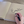 Close-up of author Ember Gene signing a copy of the children’s book Old Clothes with a black marker on the book’s front endpaper, shown on a wooden table