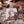 The children’s book Old Clothes displayed on a wooden table surrounded by vintage family photographs, colored pencils, antique keepsake boxes, and a dancing music box, creating a nostalgic old-fashioned atmosphere.