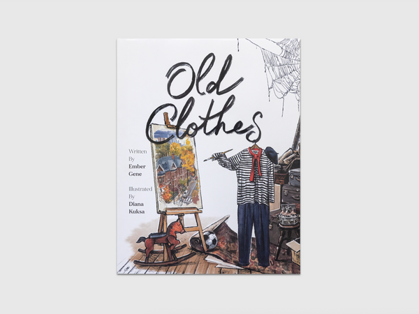 Illustrated cover of the children’s book Old Clothes featuring vintage bodiless clothing in an attic scene, including a striped shirt with a red scarf, blue pants, stacked suitcases, a rocking horse, and an easel painting. The title “Old Clothes” appears in large handwritten black lettering across the top.